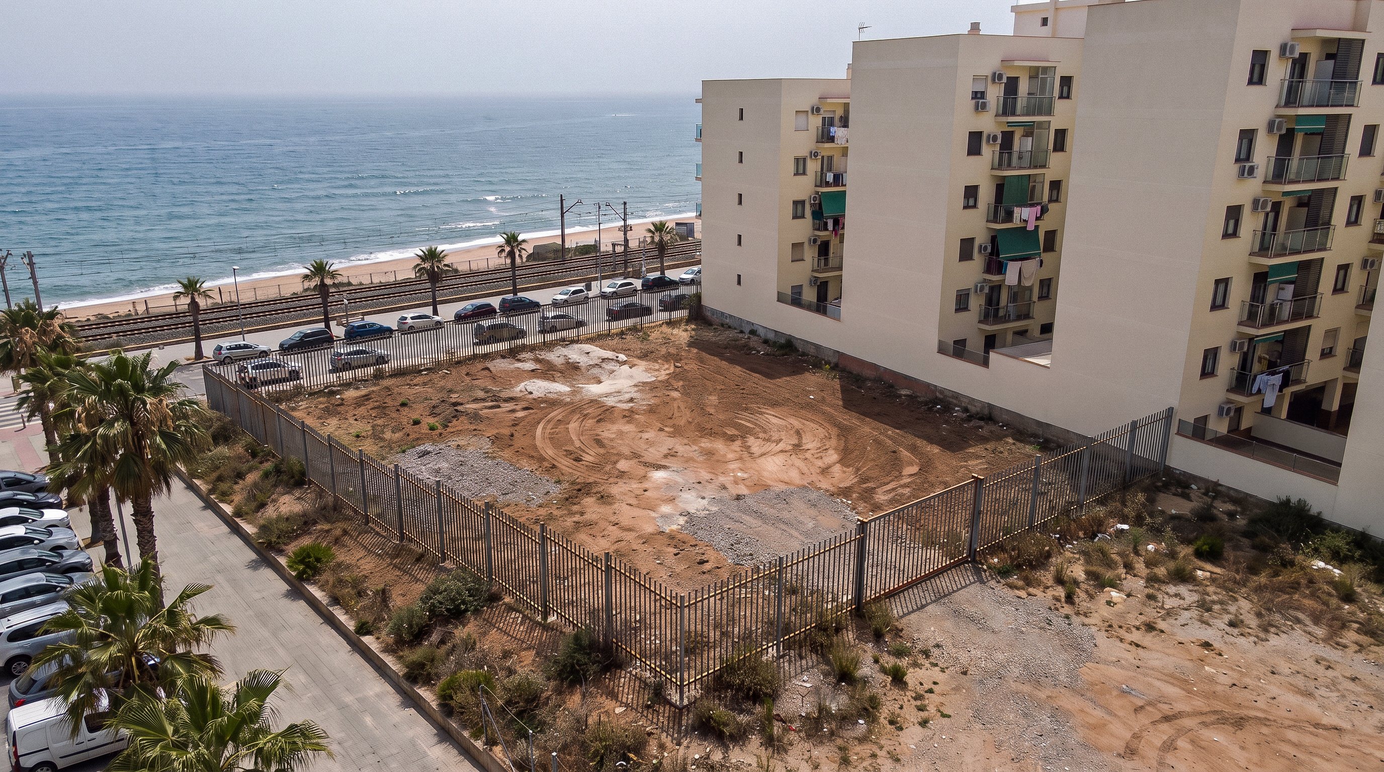 El solar vacío hoy, entre la calle, la vía del tren y la playa